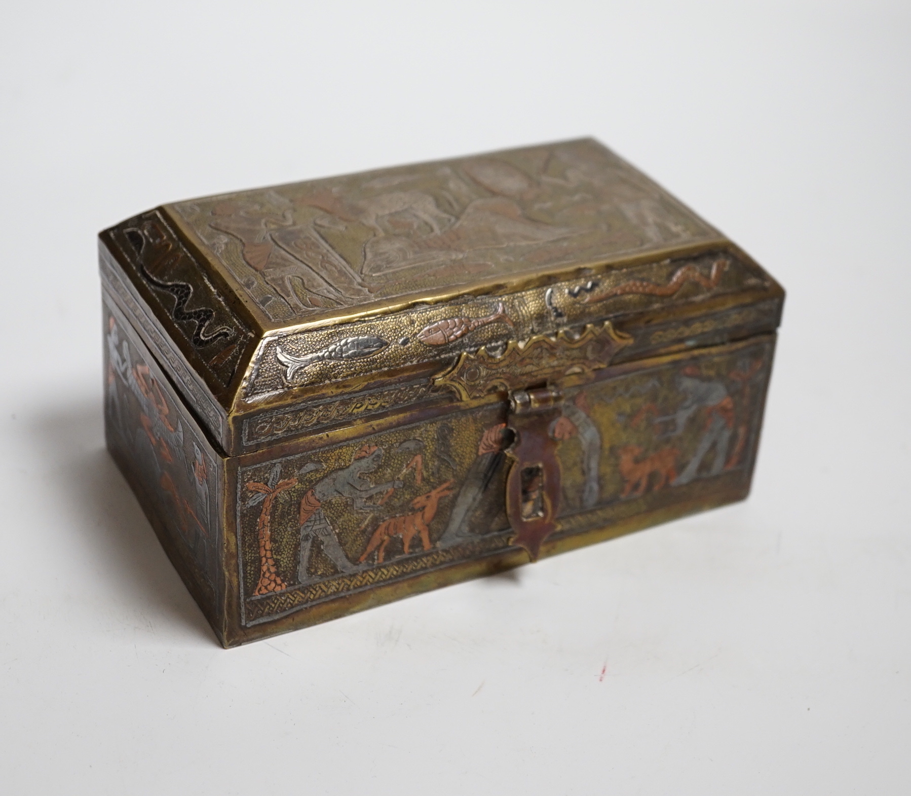 A Cairo ware box, decorated with ancient Egyptian figures, 15.5 cm wide